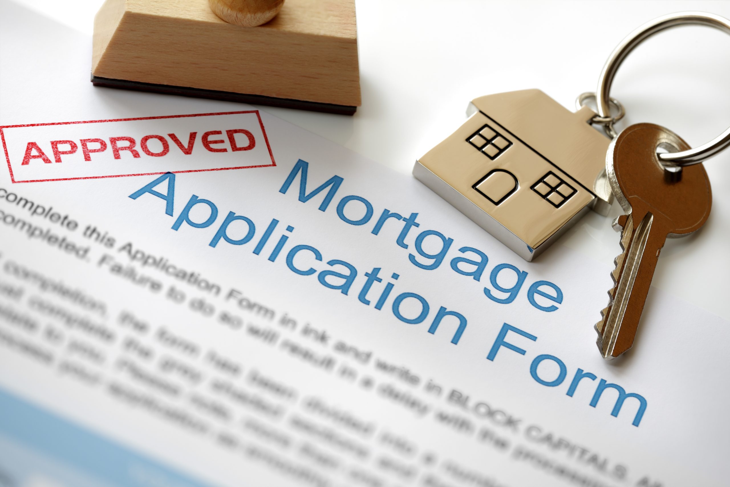 Approved,Mortgage,Loan,Application,With,House,Key,And,Rubber,Stamp